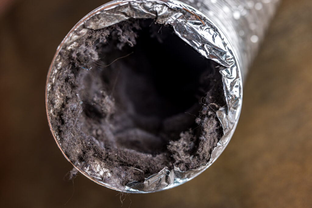 Dryer vent duct ductwork filled with lint, dust and dirt in residential Alabama home Dryer vent duct ductwork filled with lint, dust and dirt in residential Alabama home