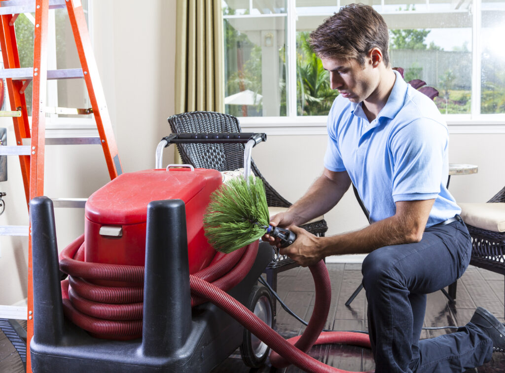 Cleaning Air Ducts Technician cleaning residential air duct in Alabama home